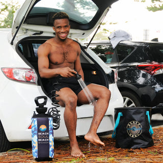 Beach Soul portable camping shower for rinsing off beside a vehicle