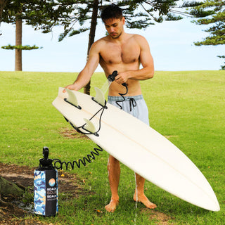 Beach Soul pressurized portable shower used to rinse a surfboard outdoors
