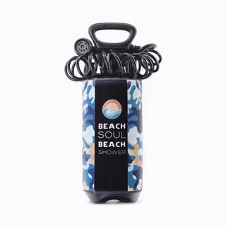 Beach Soul pressurized portable shower used to rinse a surfboard outdoors